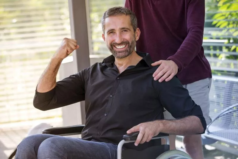 smiling man in wheel chair