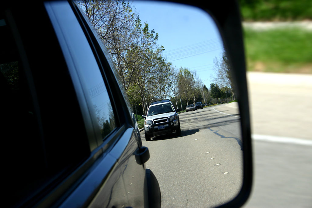 Check mirrors and stay alert for signs of distracted driving such as hitting the brakes suddenly and frequently.