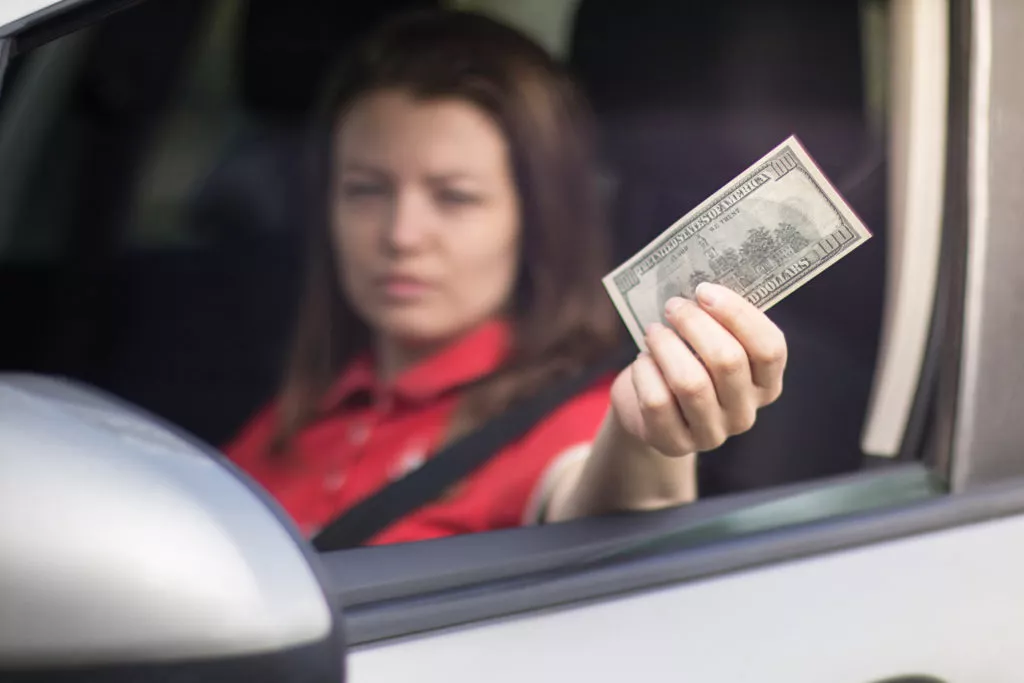 Driver offering cash to not call police after car accident in Houston.