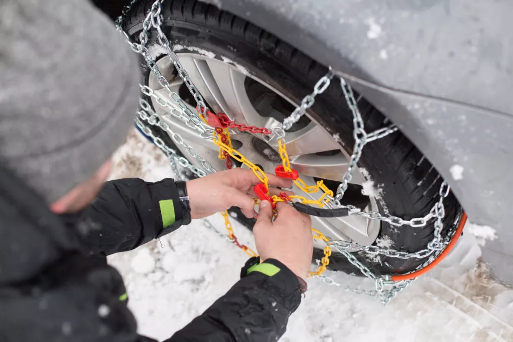 man using snow chains