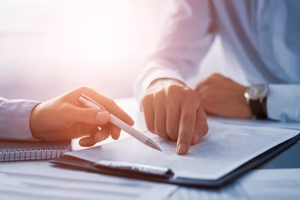 two people reviewing document